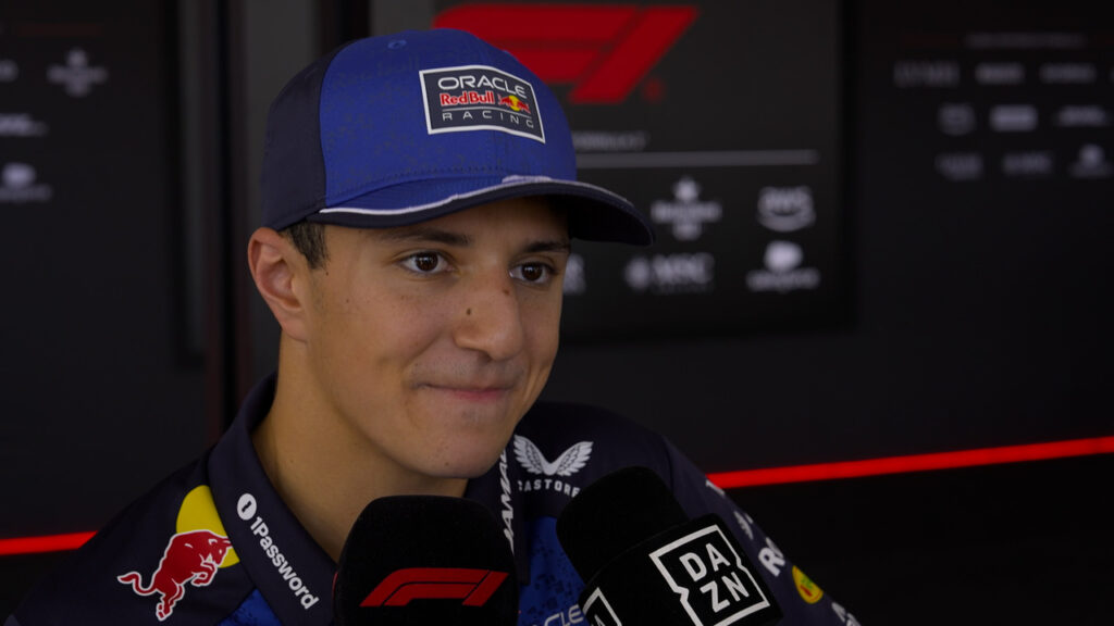 Isack Hadjar Red Bull contract: Isack Hadjar in Red Bull Racing attire during an interview.
