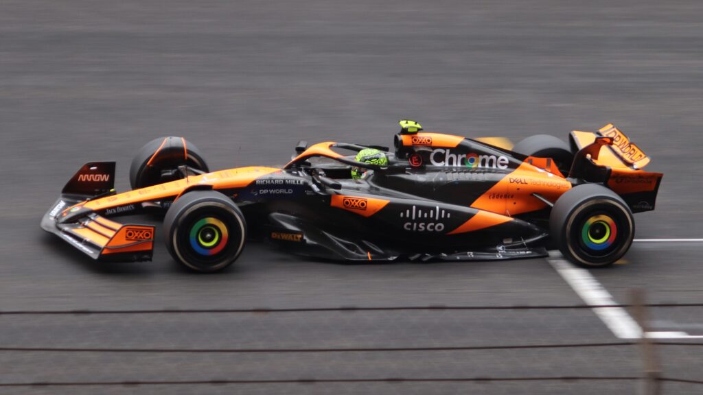 Lando Norris driving a McLaren Formula 1 car on track.