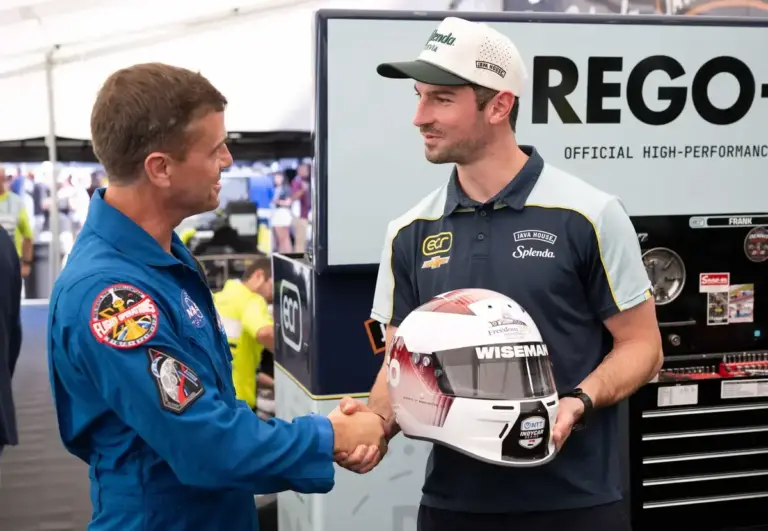August 24, 2026: NASA astronaut Reid Wiseman, Artemis II commander, is presented the helmet he will wear while taking a lap in the fastest seat in sport by Alexander Rossi, driver of the #20 car, ahead of the Freedom 250 Grand Prix, Sunday, Aug. 23,