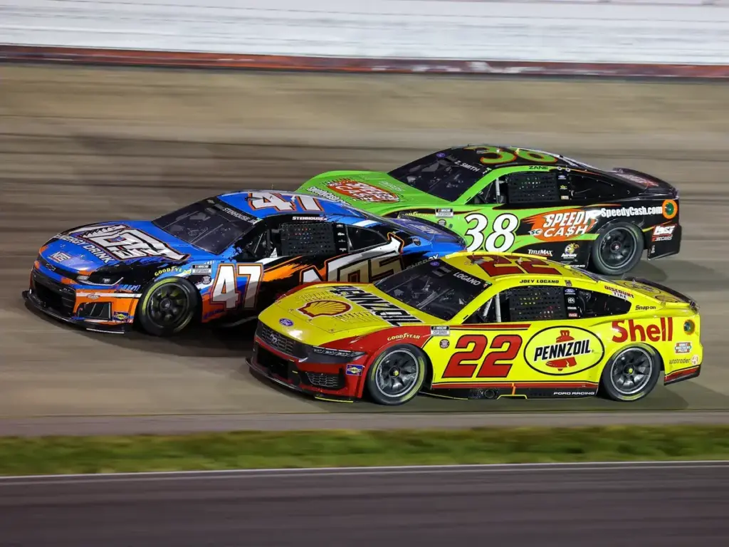May 31, 2026, Lebanon, Tennessee, USA: Team Penske Racing driver Joey Logano (22), Hyak Motorsports driver Ricky Stenhouse Jr (47), and Front Row Motorsports driver Zane Smith (38) race three wide during the Cracker Barrel 400 NASCAR Cup Series race