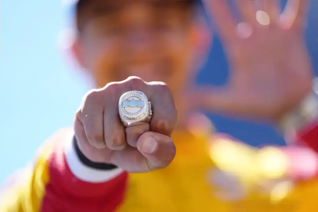 September 6, 2026, Monterey, California, USA: Alex Palou (Spain) driver of the #10 Chip Ganassi Racing Honda, celebrates his winning of the 2026 IndyCar Championship on the podium and shows off his championship ring following the IndyCar race at Wea
