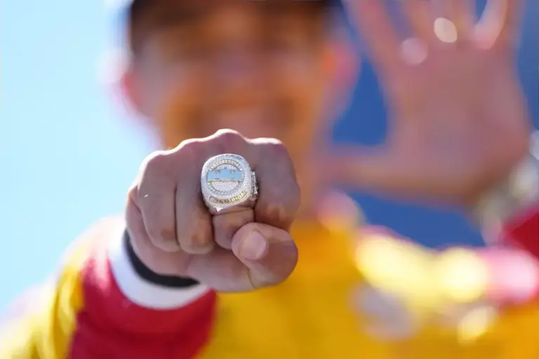 September 6, 2026, Monterey, California, USA: Alex Palou (Spain) driver of the #10 Chip Ganassi Racing Honda, celebrates his winning of the 2026 IndyCar Championship on the podium and shows off his championship ring following the IndyCar race at Wea