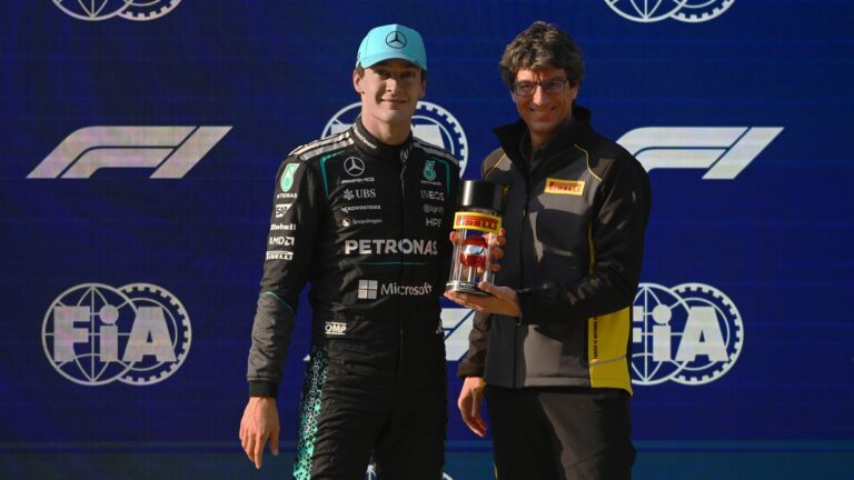 George Russell receiving an award from Dario Marrafuschi