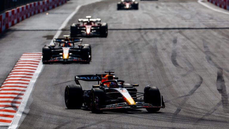F1 cars racing at the Azerbaijan Grand Prix street circuit in Baku.