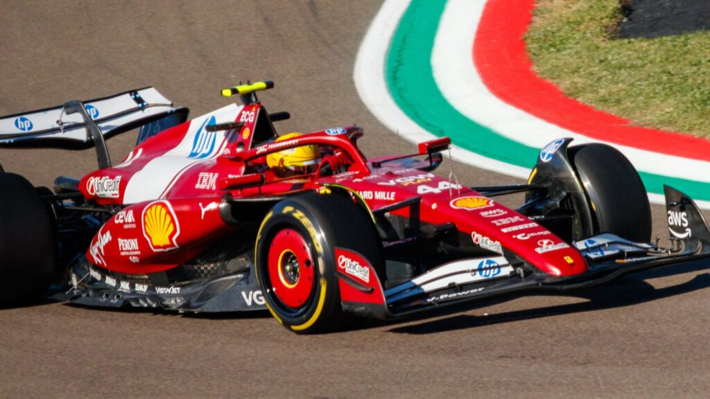 Imola F1 season finale: Lewis Hamilton driving a Ferrari F1 car on track at Imola, recognizable by the Italian tricolor kerbs.