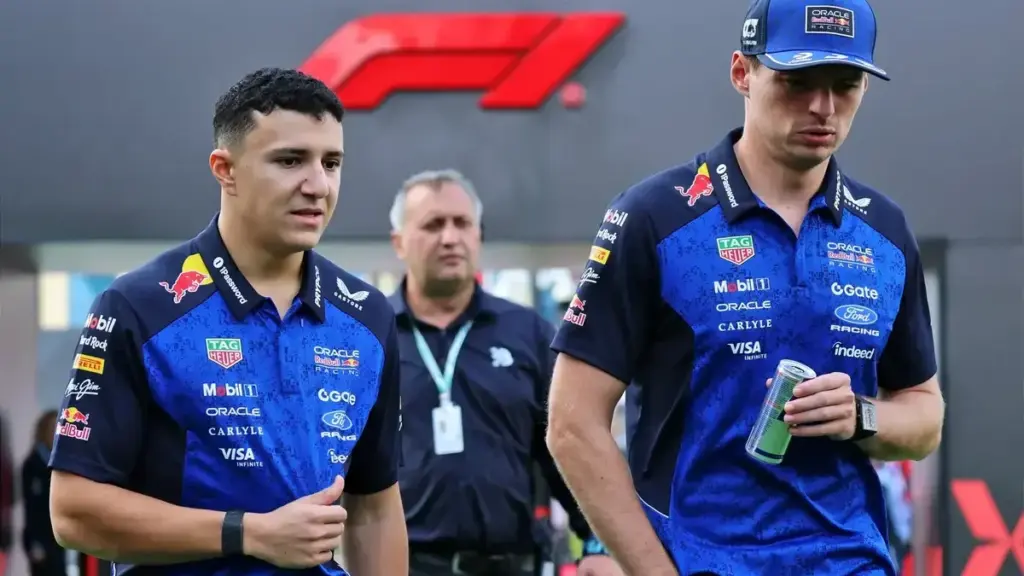 Verstappen FP2: Max Verstappen walking in the F1 paddock alongside a Red Bull teammate/staff member, at a recent Grand Prix venue.